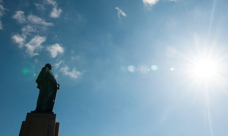 A sunny day at the University of Washington Seattle campus, silhouette of George Washington statue.