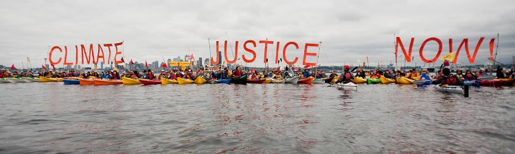 kayakers with signs