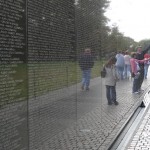 Visitors touch names and leave gifts at the Vietnam War Memorial in Washington, D.C., in 2006.