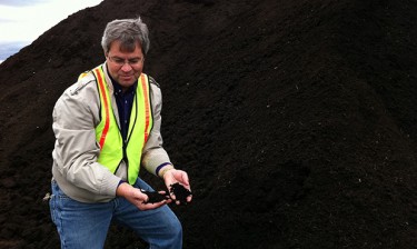 Chuck Rice, a Kansas State University professor, with a finished pile of food and yard waste compost.