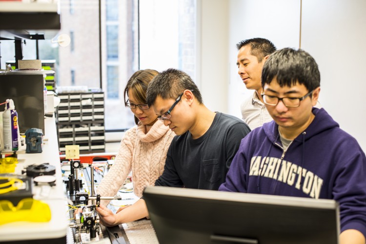 UW mechanical engineering doctoral students and assistant professor Jonathan T.C. Liu work to align a handheld microscope for cancer detection in patients. From left to right: Ye Chen, Linpeng "Peter" Wei, Liu and Chengbo Yin.