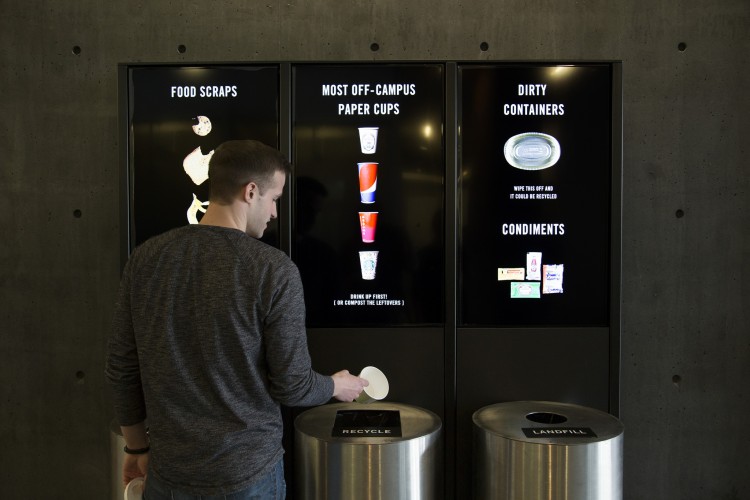 A new installation at PACCAR Hall by design professors Karen Cheng and Kristine Matthews tells users how much money has been saved by correctly sorting items for composting, recycling or sending to the landfill.