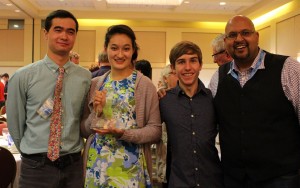 four people with trophy