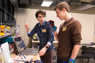 Navid Azodi (left) and Thomas Pryor (right) refine their SignAloud system in the UW CoMotion MakerSpace, where they developed the award-winning technology.