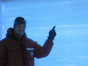 person in red coat pointing at ice