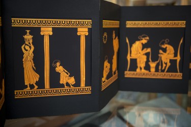 A page from the artist book "A Woman's Work," created by former student Emma Schulte with Kathryn Topper, UW associate professor of classics. The book explores what Greek faces would look like if they showed the work Greek women actually did.
