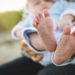 baby with sandy feet