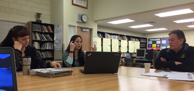 Geri Flett, left, and Launa Phillips, tribal members and teachers in the Wellpinit School District, meet with Warren Seyler, a curriculum consultant for the district.