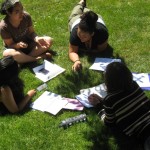 Student participants in the 2104 Summer Institute in the Arts and Humanities study and share together on a sunny day.