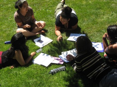 Student participants in the 2104 Summer Institute in the Arts and Humanities study and share together on a sunny day.