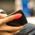 Photo of HemaApp illuminating a patient's finger