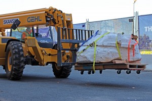 UW Burke Museum paleontologists and crew members from Skanska carefully move the 3,500-pound T. rex skull using a forklift.