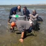 Marco Hatch works with native students to instrument mudflats of Puget Sound for environmental data collection.