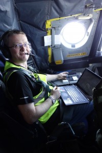 person in plane with laptop