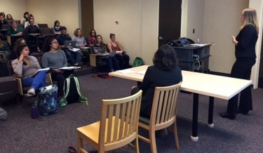 Erica Klyce, far right, with Auburn speaks with graduate students in India Ornelas' class.