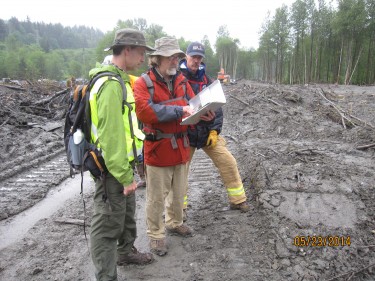 The new center builds on the UW team’s post-disaster data collection expertise. Here, lead principal investigator Joe Wartman (left) reviews field notes following the 2014 Oso Landslide.
