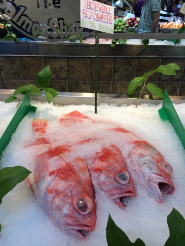 Fish labeled red snapper seen on ice in a fish market.