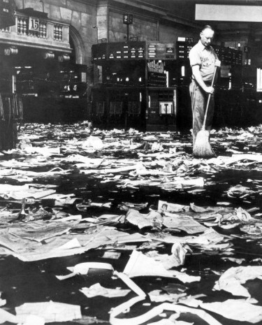 A cleaner sweeps the floor after the Wall Street crash of 1929.