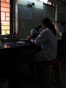 A scientist at a microscope.