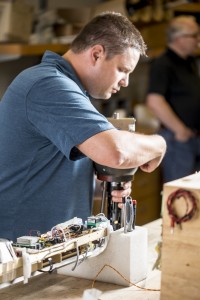 researcher leaning over instrument