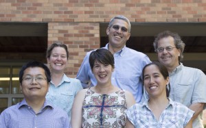 Six people standing in front of a building.