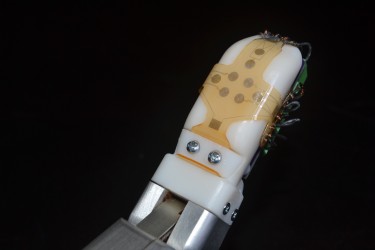 The bio-inspired sensor skin developed by University of Washington and UCLA engineers can be wrapped around a finger or any other part of a robot or prosthetic device to help convey a sense of touch.