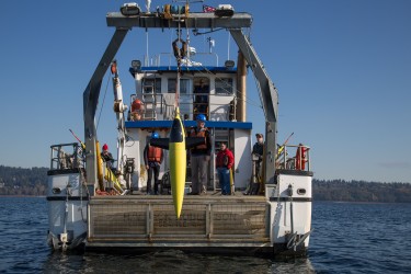 yellow glider hanging off ship