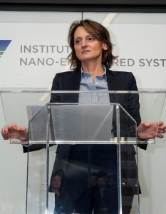 A woman speaking at a podium.