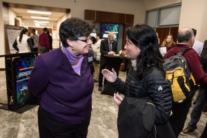 UW President Ana Mari Cauce speaking with Miqin Zhang, a UW professor of materials science and engineering, at the launch of NW IMPACT on Jan. 31.