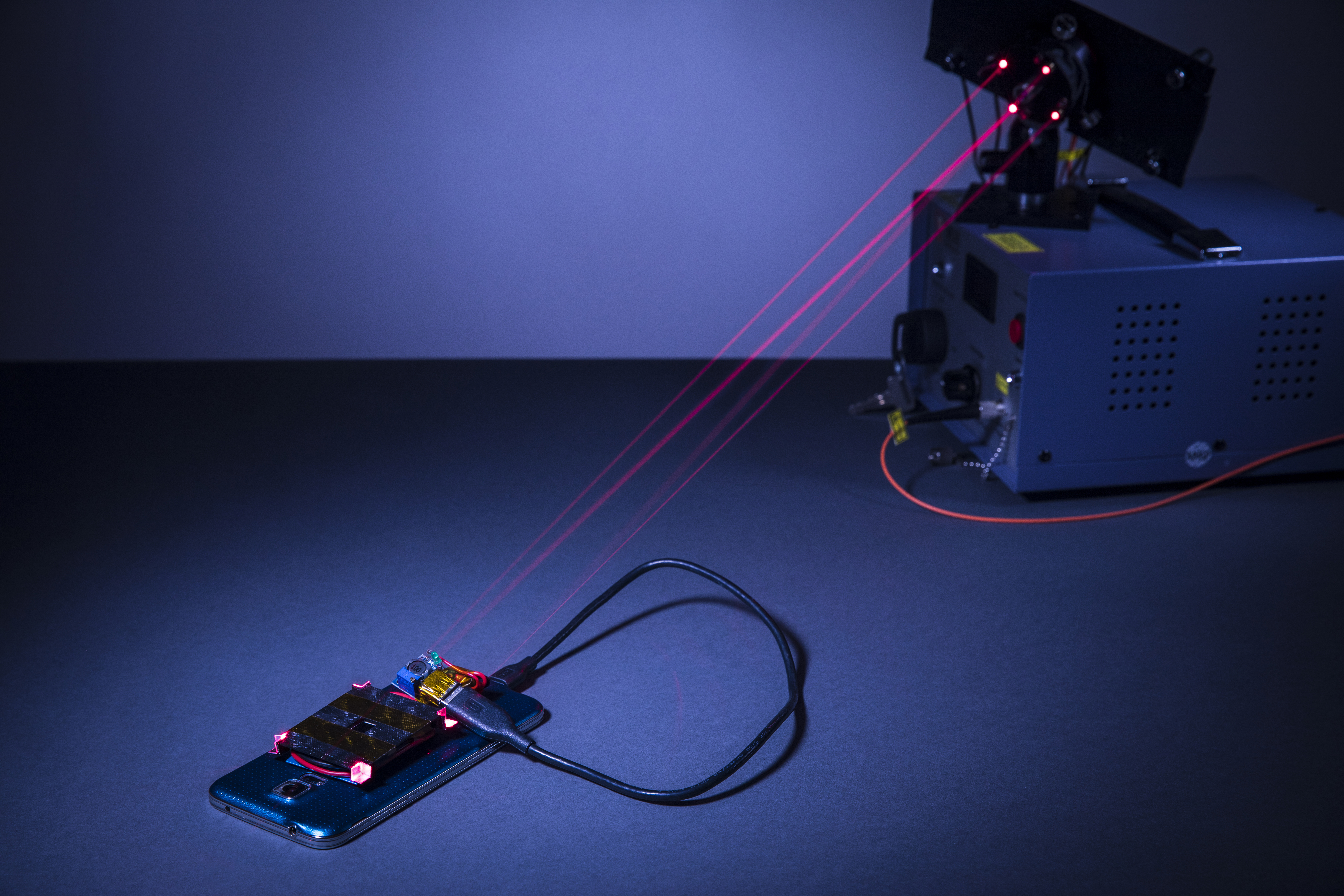 using a laser to wirelessly charge a smartphone safely a leser