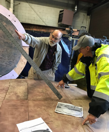 Woody Sullivan, UW professor emeritus of astronomy, consults with Larry Tate, principal at Seattle's Fabrication Specialties Ltd., right, on the necessary angle and placement of a new gnomon to ensure the time-keeping accuracy of Olympia's Territorial Sundial.
