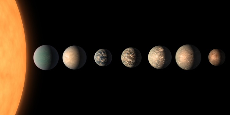 This artist's concept shows what the TRAPPIST-1 planetary system may look like, based on available data about the planets' diameters, masses and distances from the host star, as of February 2018.