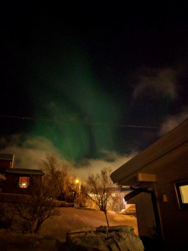 green bands of lights in dark sky