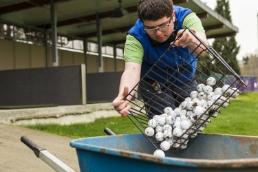 In addition to readying the driving range before it opens, Matthew Skelly also works in the flower beds and trims the hedges and blackberries. "I prefer a mixture of things to do, no matter what the weather is," he said.
