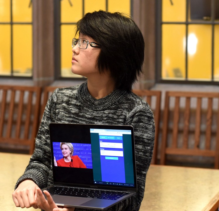 Nancy Tran shows off her group's redesign of FakeApp
