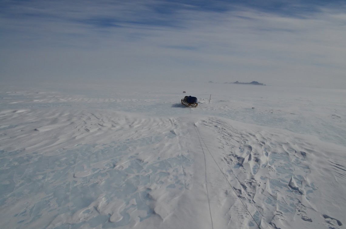 blue ice with sled in distance