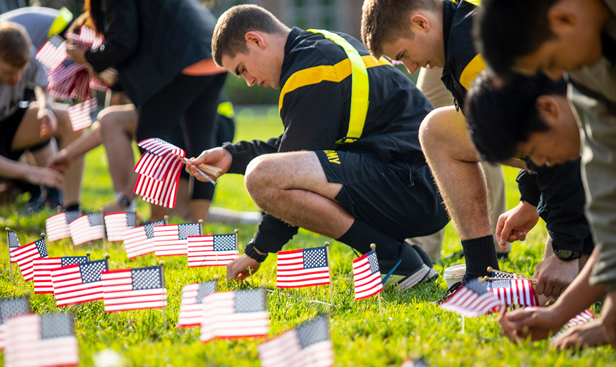 Student veterans and other volunteers place nearly 7,400 flags on the HUB lawn to recognize the number of U.S. veterans who died by suicide in one year.