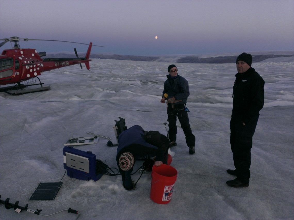 researchers standing with equipment on ice