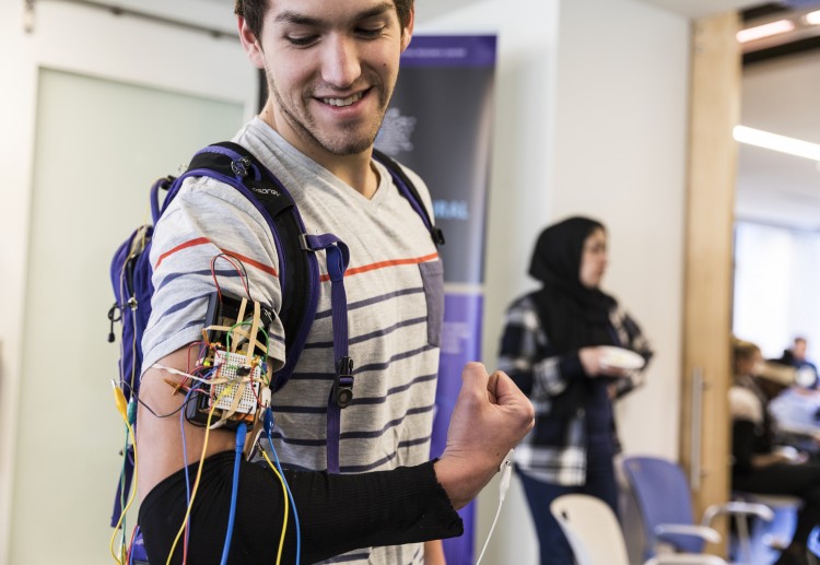 a student participating in the Hackathon wears a device controlled by muscle activity
