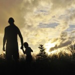 A University of Washington study finds that parents who took mindfulness lessons were better able to manage their emotions, and their children's behavior improved, as well. Photo of a father walking with his young son.