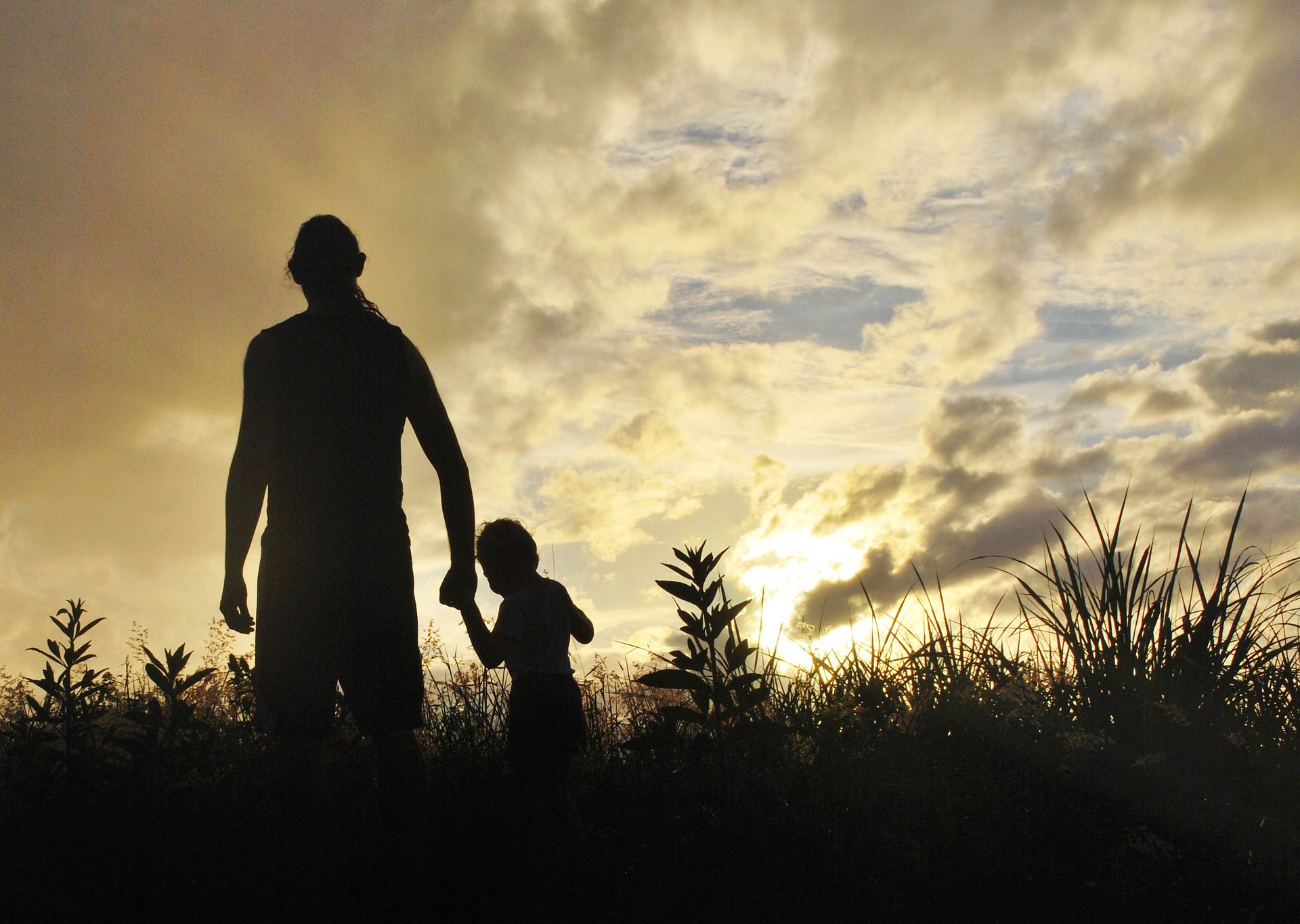 A University of Washington study finds that parents who took mindfulness lessons were better able to manage their emotions, and their children's behavior improved, as well. Photo of a father walking with his young son.