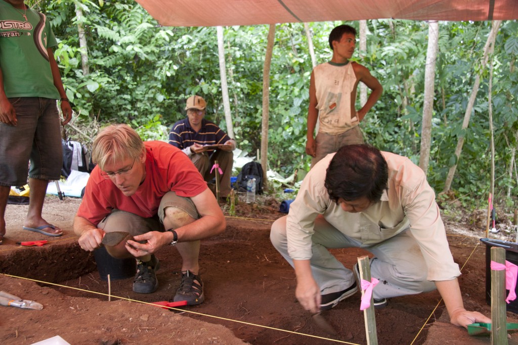 Burke Museum Archaeology Curator Peter Lape (left) and Daud Tanudirjo (right) excavating a layer at the site with the earliest known cooking use of nutmeg. Photo of two men digging at a site.