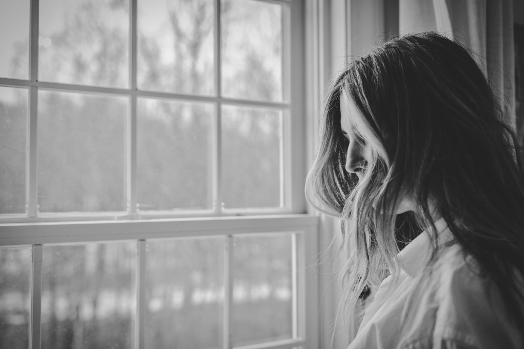 A study of PTSD patients led by the University of Washington finds that people who chose their form of treatment were more apt to stick to their program and eventually become diagnosis-free. Photo of woman looking out a window.