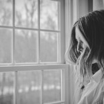 A study of PTSD patients led by the University of Washington finds that people who chose their form of treatment were more apt to stick to their program and eventually become diagnosis-free. Photo of woman looking out a window.