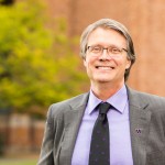 Mark Richards in front of brick building