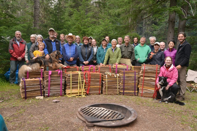 a group of people standing in a forest