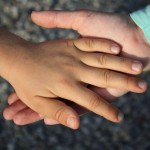 A study of 6- to 8-year-old children by the University of Washington and Temple University found that the anticipation of touch was associated with executive function skills such as selective attention and working memory. Photo of children's hands.