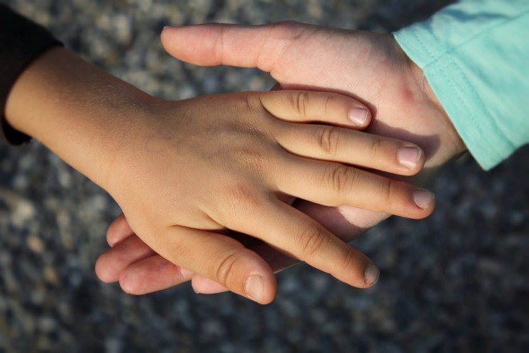 A study of 6- to 8-year-old children by the University of Washington and Temple University found that the anticipation of touch was associated with executive function skills such as selective attention and working memory. Photo of children's hands.