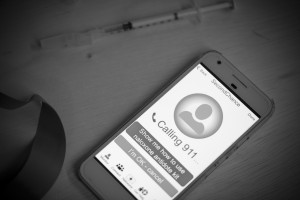 A cellphone displays a message saying that it is calling 911 because a person hasn't responded.
