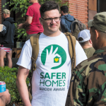 Forefront Program Coordinator Brett Bass joins fellow veterans to build awareness about the Save Homes, Suicide Aware program. Photo of Brett talking to two veterans.